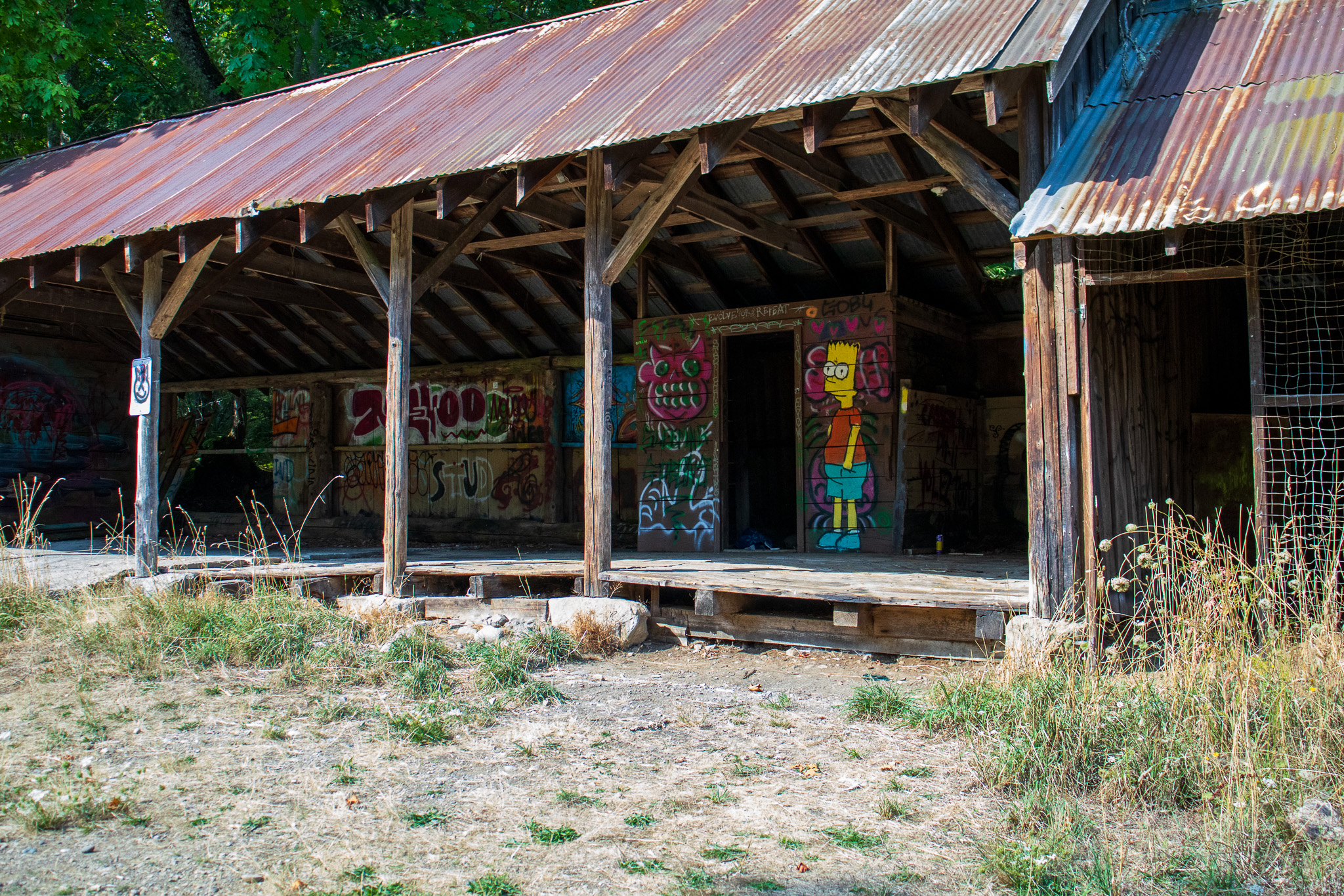 A graffiti covered old wood building frame.